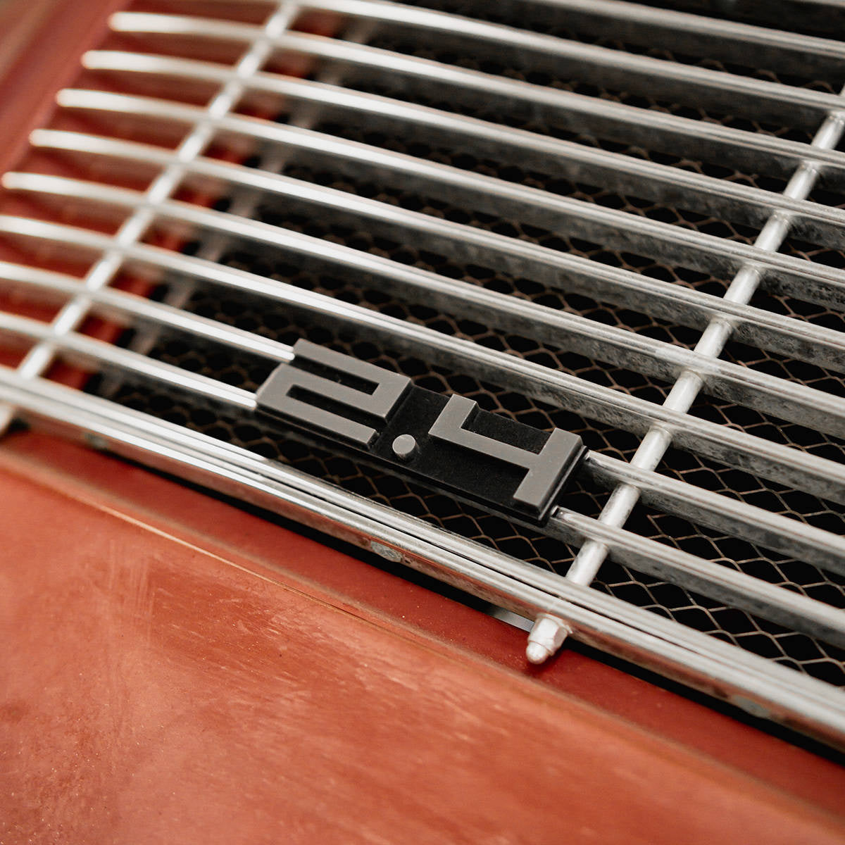 Rear deck lid grille displacement badge/emblem