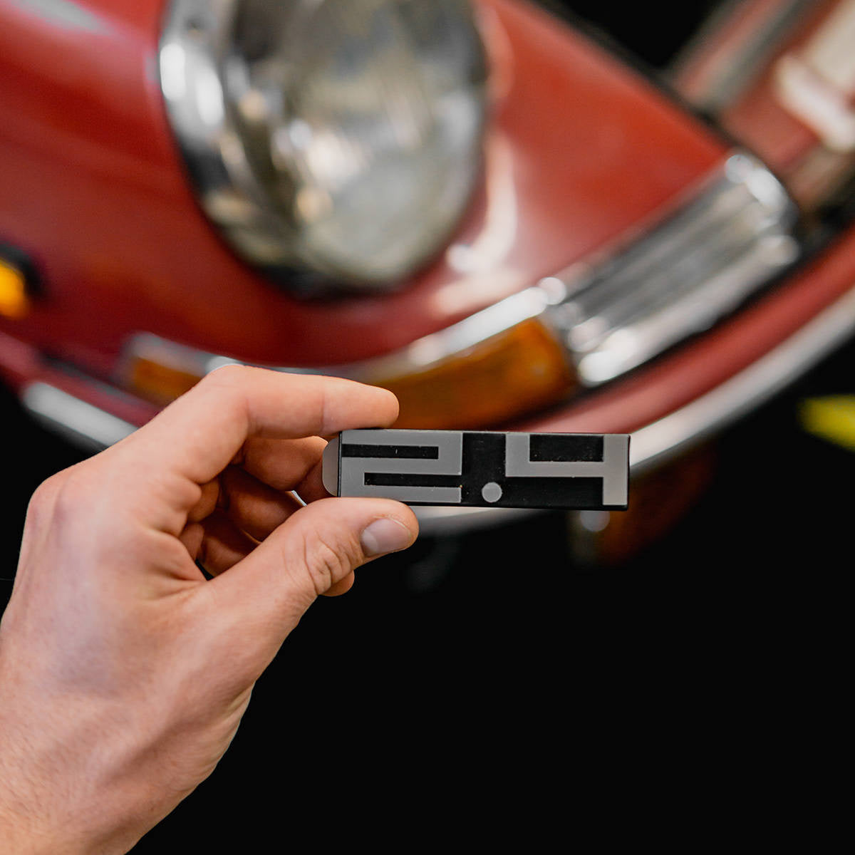 Rear deck lid grille displacement badge/emblem